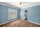 Carpeted bedroom with window and blue walls leading into ensuite bathroom at 226 Euharlee Five Forks Rd, Kingston, GA 30145