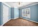 Bright bedroom featuring light blue walls, white trim, a ceiling fan, and a window with plantation shutters at 226 Euharlee Five Forks Rd, Kingston, GA 30145