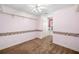 Carpeted bedroom featuring pink walls, white trim, a ceiling fan, and decorative border at 226 Euharlee Five Forks Rd, Kingston, GA 30145
