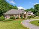 Brick home with a circular drive, well-manicured lawn and mature landscaping at 226 Euharlee Five Forks Rd, Kingston, GA 30145