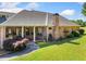 Brick home featuring a covered porch with pillars and a lush green lawn at 226 Euharlee Five Forks Rd, Kingston, GA 30145