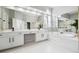 Bright bathroom featuring double sinks, a soaking tub, and large mirrors for a luxurious and spacious feel at 325 Stonecastle Sw Pass, Atlanta, GA 30331
