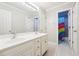 Bathroom features double sinks, white cabinets, tile floor, and an adjoining colorful shower room at 325 Stonecastle Sw Pass, Atlanta, GA 30331