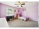 Comfortable purple bedroom with a decorative canopy, soft carpet, and a bright window at 325 Stonecastle Sw Pass, Atlanta, GA 30331