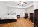 Comfortable bedroom featuring wood-look floors, a ceiling fan, and a double door closet at 325 Stonecastle Sw Pass, Atlanta, GA 30331
