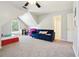 Spacious bonus room features a large blue couch and plenty of natural light, perfect for relaxation at 325 Stonecastle Sw Pass, Atlanta, GA 30331