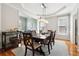 Elegant dining room features hardwood floors, tray ceiling, chandelier, and access to living spaces, perfect for entertaining at 325 Stonecastle Sw Pass, Atlanta, GA 30331