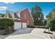Exterior of a brick home featuring an attached garage, and a basketball hoop on the driveway at 325 Stonecastle Sw Pass, Atlanta, GA 30331