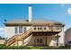 Back exterior featuring a wooden deck with stairs to the well manicured lawn at 325 Stonecastle Sw Pass, Atlanta, GA 30331