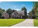 Beautiful home with a well-manicured lawn, mature trees, and a long driveway at 325 Stonecastle Sw Pass, Atlanta, GA 30331