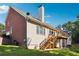 Back exterior of a home with a deck and stairs leading to the yard at 325 Stonecastle Sw Pass, Atlanta, GA 30331