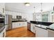 Modern kitchen features granite countertops, stainless steel appliances, and white cabinets with brass hardware at 325 Stonecastle Sw Pass, Atlanta, GA 30331