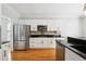 Well-appointed kitchen features granite counters, stainless steel appliances, white cabinets and hardwood floors at 325 Stonecastle Sw Pass, Atlanta, GA 30331