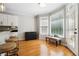 Bright eat-in kitchen with hardwood floors, freezer, and bench seating near large windows at 325 Stonecastle Sw Pass, Atlanta, GA 30331