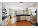 Open kitchen boasts granite countertops, white cabinets, stainless appliances, and hardwood floors, perfect for modern living at 325 Stonecastle Sw Pass, Atlanta, GA 30331