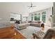 Open-concept living room with hardwood floors, fireplace, and views of eat-in kitchen at 325 Stonecastle Sw Pass, Atlanta, GA 30331