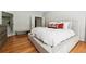 Cozy primary bedroom showcases hardwood floors, a comfortable bed, and an en-suite bathroom at 325 Stonecastle Sw Pass, Atlanta, GA 30331