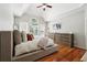 Primary bedroom offers vaulted ceiling, hardwood floors, large windows, and ample natural light at 325 Stonecastle Sw Pass, Atlanta, GA 30331