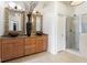 Stylish bathroom features double sinks, granite countertops, and a glass-enclosed shower creating a modern and functional space at 196 Mystic Ct, Atlanta, GA 30342