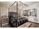 Luxurious bedroom with a four-poster bed, mirrored accents, and elegant decor at 196 Mystic Ct, Atlanta, GA 30342