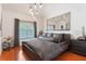 Modern bedroom with unique lighting, hardwood floors, and a large decorative mirror over the bed at 196 Mystic Ct, Atlanta, GA 30342
