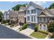 Attractive exterior view of a row of townhomes with well-manicured lawns and mature trees at 196 Mystic Ct, Atlanta, GA 30342