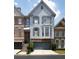 Townhome featuring gray siding, stone accents, bay windows, and an attached two-car garage at 196 Mystic Ct, Atlanta, GA 30342