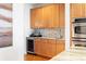 Kitchen wet bar with stainless steel appliances, light wood cabinets, and tiled backsplash, perfect for entertaining guests at 196 Mystic Ct, Atlanta, GA 30342