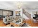 Spacious living area with hardwood floors, natural light, a plush sofa, and a statement chandelier at 196 Mystic Ct, Atlanta, GA 30342