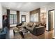 Inviting living room featuring hardwood floors, stylish sofa, and a glimpse into the adjacent bedroom at 196 Mystic Ct, Atlanta, GA 30342