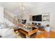 Open-concept living room featuring hardwood floors, modern decor, and a statement chandelier at 196 Mystic Ct, Atlanta, GA 30342