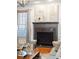 Cozy living room with hardwood floors, fireplace, mantel, and lots of natural light at 196 Mystic Ct, Atlanta, GA 30342