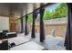 Covered patio with comfortable seating and privacy curtains, perfect for outdoor relaxation at 196 Mystic Ct, Atlanta, GA 30342