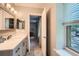 Bathroom features a patterned tile floor, vanity, and open doorway to a bedroom at 3440 Ashwood Ln, Atlanta, GA 30341