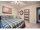 Bedroom with a comfortable bed, hardwood floors, ceiling fan and empty bookshelf at 3440 Ashwood Ln, Atlanta, GA 30341
