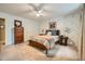 Bedroom with carpet, ceiling fan, floral wallpaper, and a wood bed frame at 3440 Ashwood Ln, Atlanta, GA 30341
