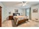 Bedroom featuring light colored carpet, floral wallpaper, and a ceiling fan at 3440 Ashwood Ln, Atlanta, GA 30341