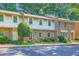 Charming townhouse with shake siding, brick accents, a well-manicured lawn, and a vibrant red front door at 3440 Ashwood Ln, Atlanta, GA 30341