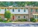 Charming townhouse with shake siding, brick accents, a well-manicured lawn, and a vibrant red front door at 3440 Ashwood Ln, Atlanta, GA 30341