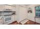 Cozy kitchen with tiled backsplash, wood floors, and white appliances at 3440 Ashwood Ln, Atlanta, GA 30341
