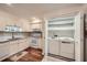 Bright kitchen includes white cabinets and a laundry closet with a washer and dryer at 3440 Ashwood Ln, Atlanta, GA 30341