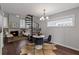 Dining area showcases a modern chandelier, dark chairs, and seamless flow to the living space at 836 Saint Charles Ne Ave # I, Atlanta, GA 30306