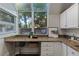 Bright kitchen nook features granite countertops, white cabinets, and a large window overlooking lush greenery at 836 Saint Charles Ne Ave # I, Atlanta, GA 30306