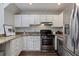 Kitchenette offers sleek stainless steel appliances, bright white cabinets, and durable granite countertops at 836 Saint Charles Ne Ave # I, Atlanta, GA 30306