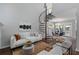 Open-concept living area with a spiral staircase, fireplace, and dining space with modern decor at 836 Saint Charles Ne Ave # I, Atlanta, GA 30306