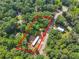 Aerial view of property surrounded by lush trees, with a red outline marking the property boundaries at 4820 Scott Rd, Cumming, GA 30041