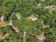 Aerial view of wooded community with mature trees, homes and winding roads at 4820 Scott Rd, Cumming, GA 30041