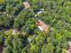Aerial view of a property with a mobile home nestled among lush, mature green trees at 4820 Scott Rd, Cumming, GA 30041