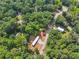 An aerial view of a property with a mobile home, additional building, and surrounding trees at 4820 Scott Rd, Cumming, GA 30041