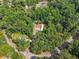 An aerial view showing a mobile home on a wooded lot with surrounding trees and streets at 4820 Scott Rd, Cumming, GA 30041
